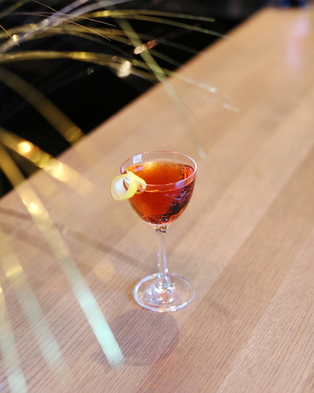 Photo of a red cocktail on Mordecai's bar.